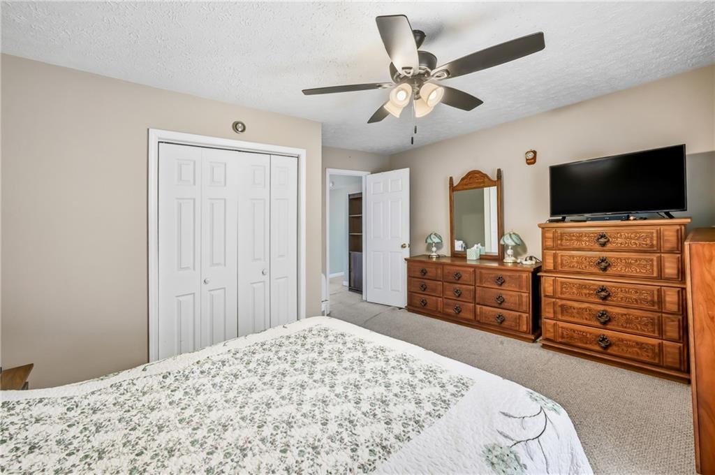 181 West Jamestown Road Greenville, PA 16125 - Photo 38 of 49 a bedroom with a bed and a flat tv screen on dresser