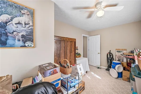a living room with furniture a flat screen tv and a potted plant