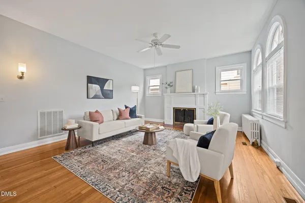 a living room with furniture fireplace and window