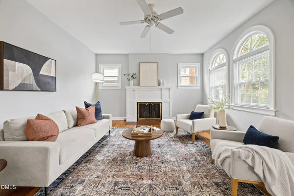 a living room with furniture fireplace and window