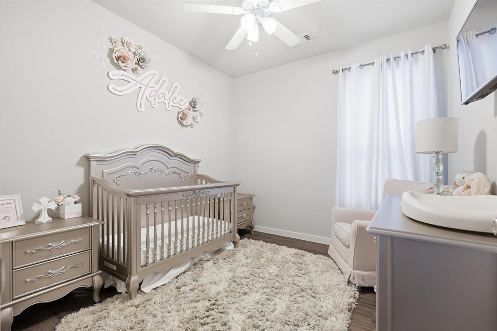 5582 Yarborough Drive Forney, TX 75126 - Photo 12 of 29 a bedroom with a bed and a table in it