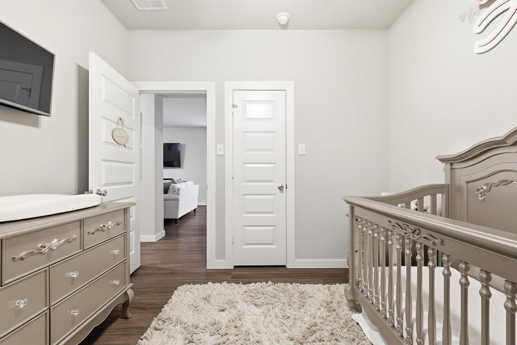 5582 Yarborough Drive Forney, TX 75126 - Photo 13 of 29 a bedroom with a bed and a dresser
