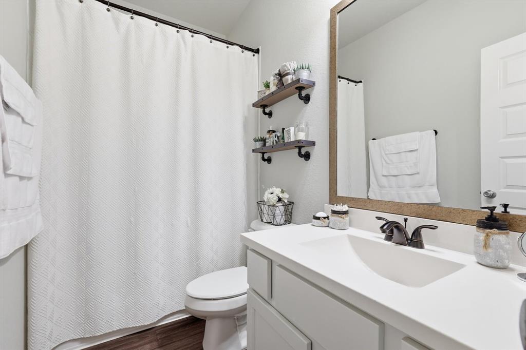 5582 Yarborough Drive Forney, TX 75126 - Photo 14 of 29 a bathroom with a sink and a mirror