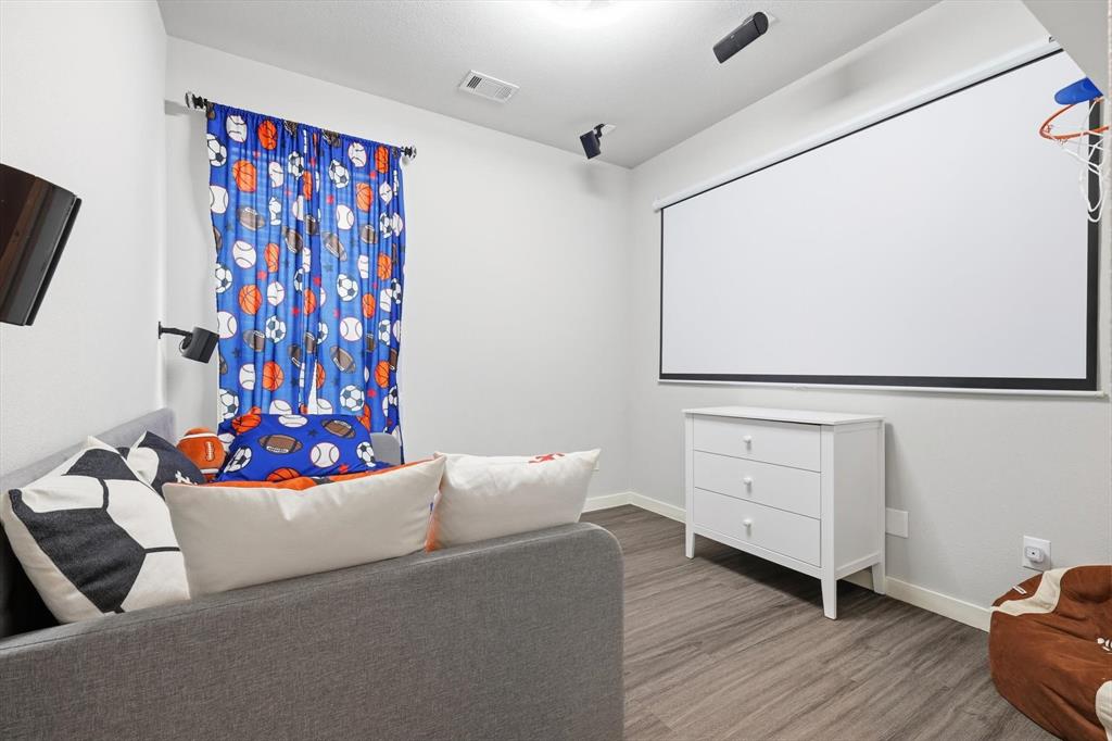 5582 Yarborough Drive Forney, TX 75126 - Photo 15 of 29 a living room with furniture and flowers