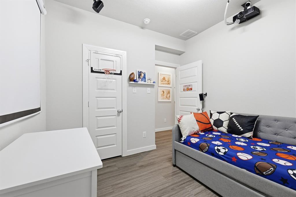 5582 Yarborough Drive Forney, TX 75126 - Photo 16 of 29 a bedroom with furniture and wooden floor