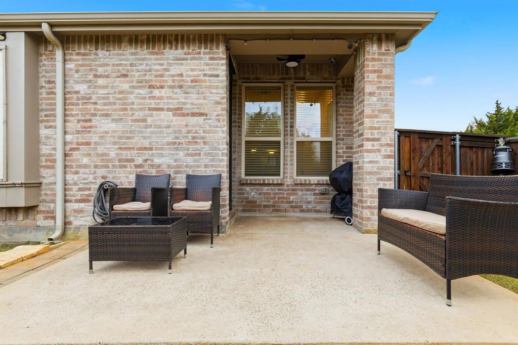 5582 Yarborough Drive Forney, TX 75126 - Photo 18 of 29 a living room with furniture and a fireplace