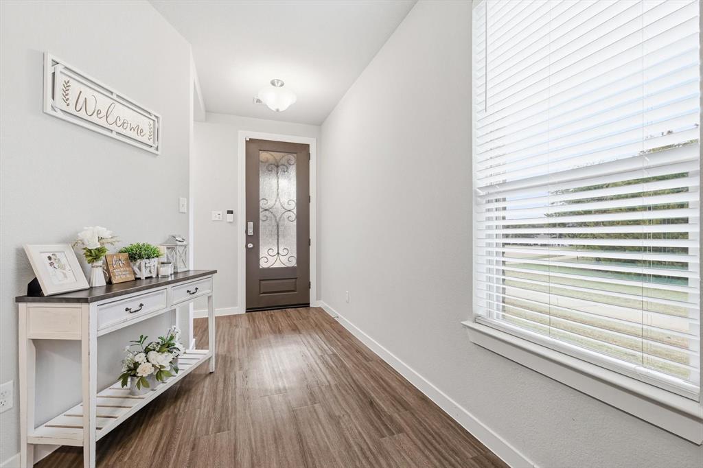 5582 Yarborough Drive Forney, TX 75126 - Photo 3 of 29 a view of a hallway to dining room and wooden floor