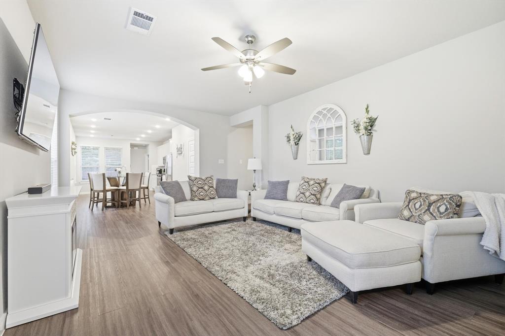 5582 Yarborough Drive Forney, TX 75126 - Photo 4 of 29 a living room with furniture and a chandelier