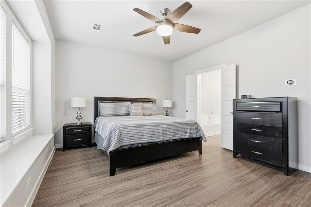 5582 Yarborough Drive Forney, TX 75126 - Photo 9 of 29 a bedroom with a bed and a ceiling fan