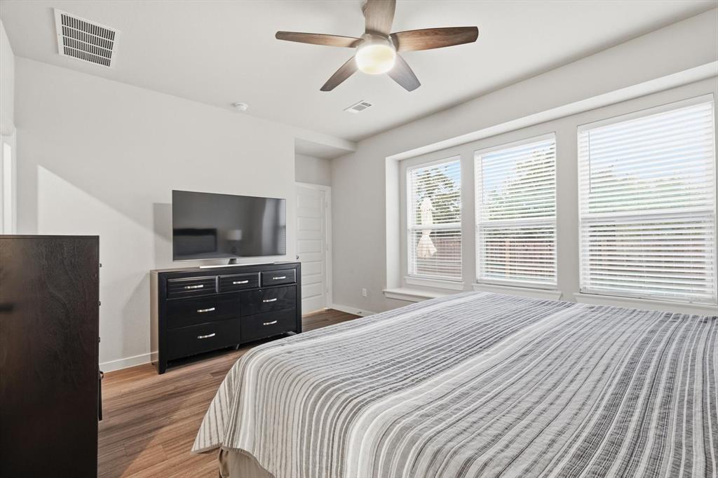 5582 Yarborough Drive Forney, TX 75126 - Photo 10 of 29 a bedroom with a bed and a flat screen tv