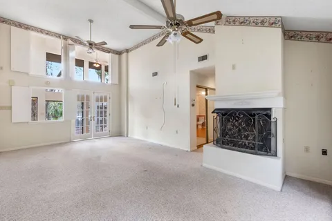 a view of livingroom with fan and kitchen view