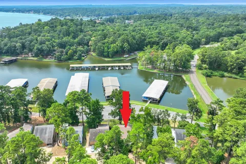 an aerial view of a house with pool lake view and mountain view