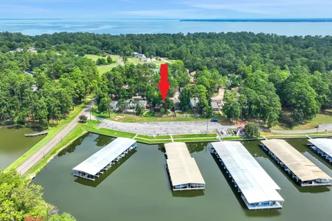 an aerial view of a tennis ground and a yard