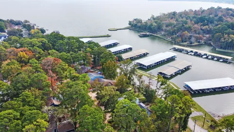an aerial view of a house with a yard and outdoor seating