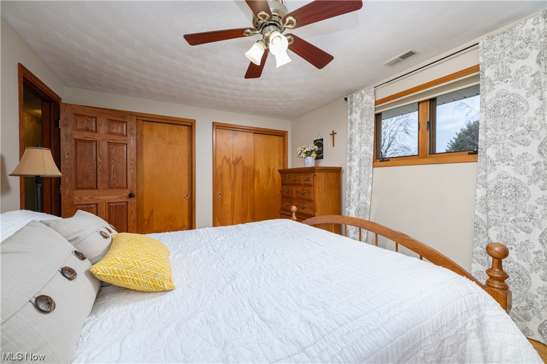 5304 Sibila Road Northwest Canton, OH 44718 - Photo 26 of 29 Bedroom with multiple closets and ceiling fan