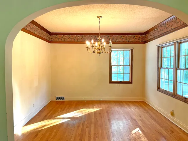 a view of a room with window and chandelier