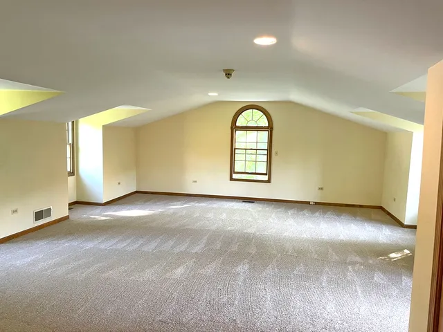 an empty room with a empty space and windows