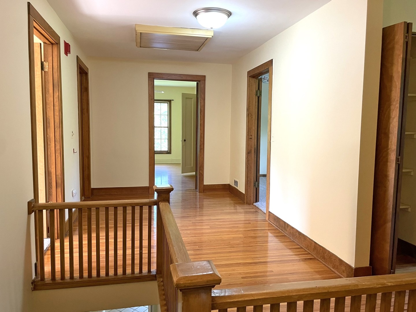 8914 Mason Hill Road Woodstock, IL 60098 - Photo 18 of 26 a view of a hallway with entryway wooden floor and front door