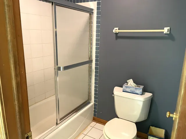 a bathroom with a toilet and a shower