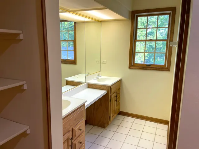 a bathroom with a sink a vanity and a mirror