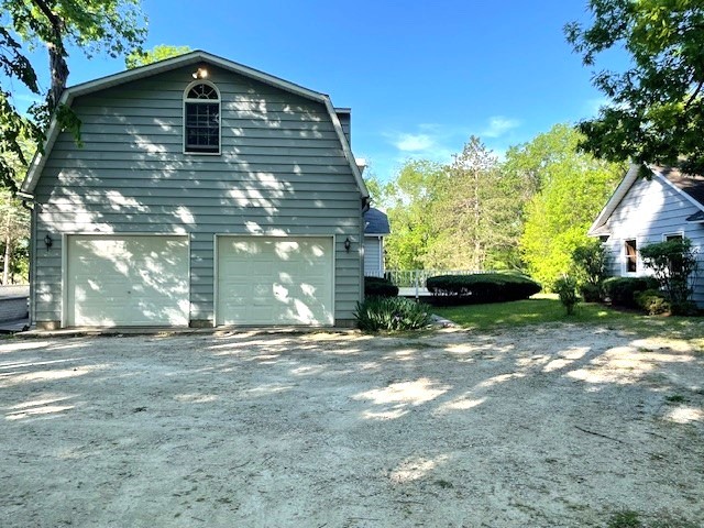 8914 Mason Hill Road Woodstock, IL 60098 - Photo 2 of 26 a front view of a house with a yard