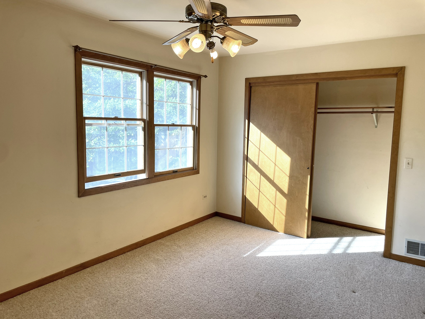 8914 Mason Hill Road Woodstock, IL 60098 - Photo 23 of 26 an empty room with windows and chandelier fan