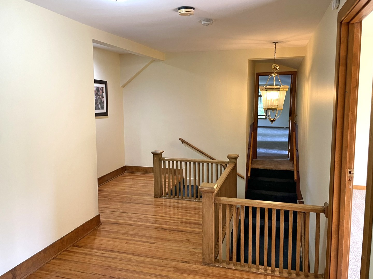 8914 Mason Hill Road Woodstock, IL 60098 - Photo 24 of 26 a view of a hallway with wooden floor and staircase