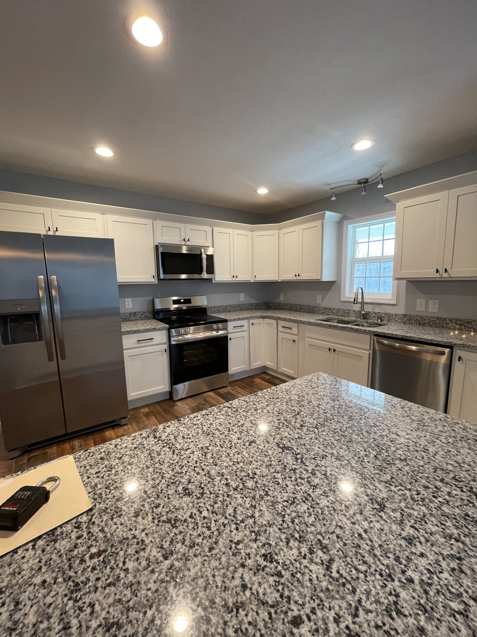 175 Gamaliel Road Red Boiling Springs, TN 37150 - Photo 12 of 18 a kitchen with granite countertop a stove sink and cabinets