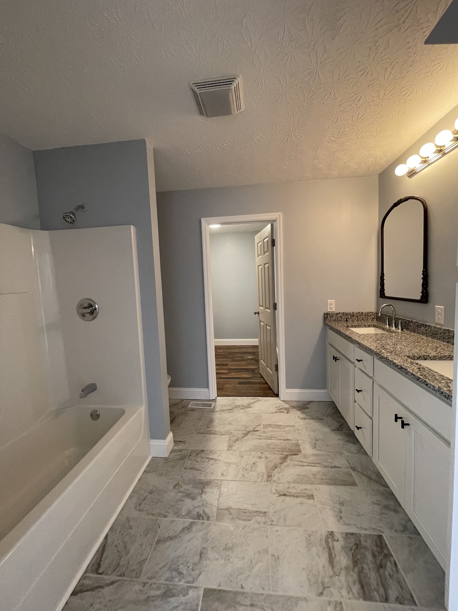 175 Gamaliel Road Red Boiling Springs, TN 37150 - Photo 9 of 18 a spacious bathroom with a bathtub sink and mirror