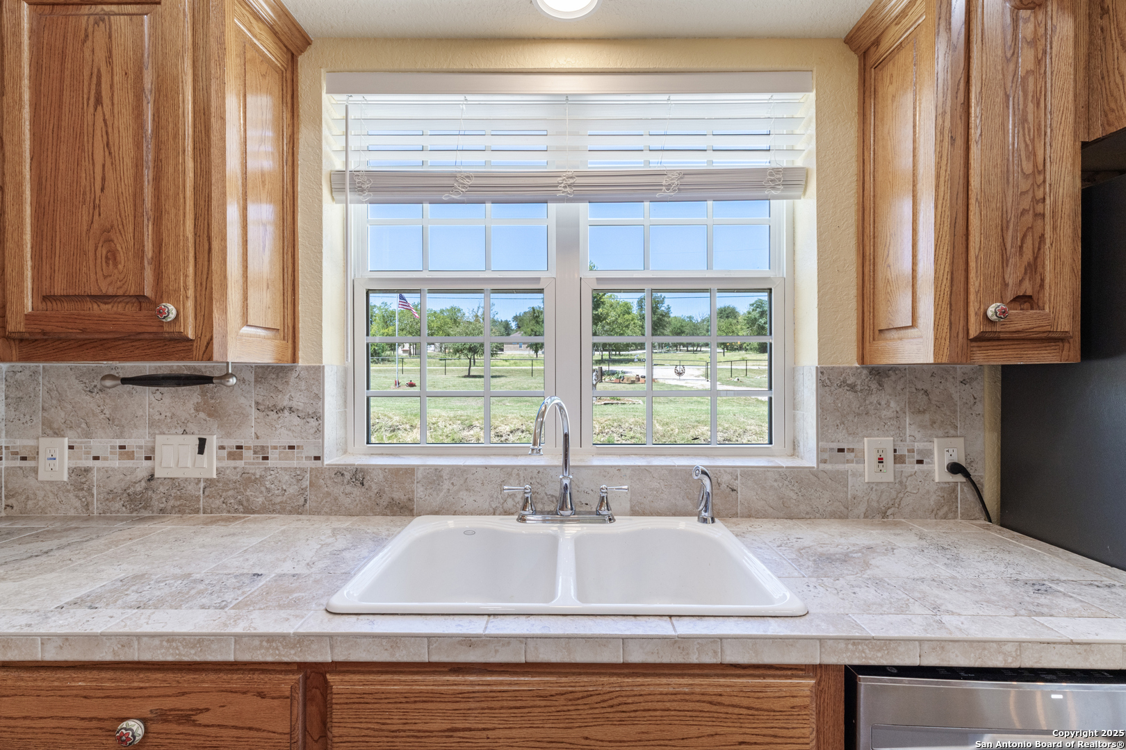 7040 Old Spring Branch Road Spring Branch, TX 78070 - Photo 12 of 43 a kitchen with granite countertop sink and window