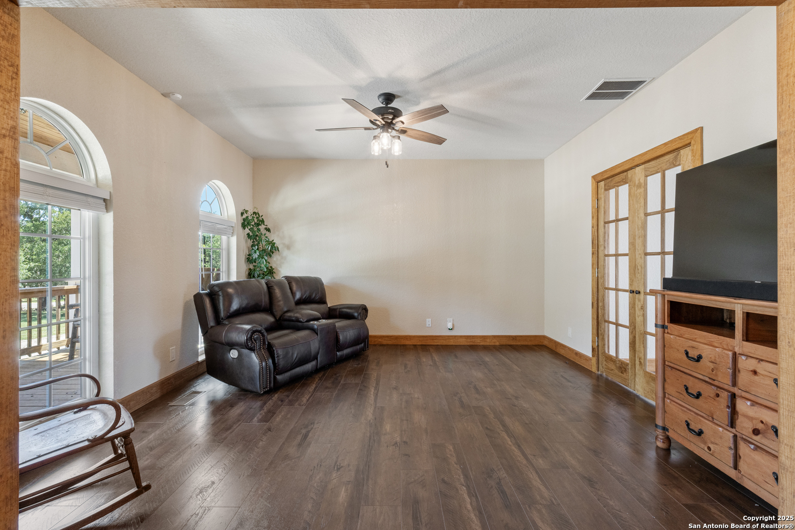 7040 Old Spring Branch Road Spring Branch, TX 78070 - Photo 18 of 43 a living room with furniture a flat screen tv and a window