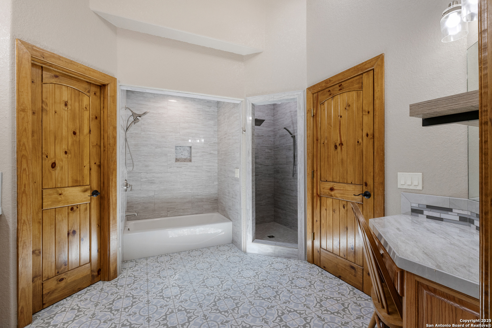 7040 Old Spring Branch Road Spring Branch, TX 78070 - Photo 23 of 43 a bathroom with a granite countertop sink a mirror and a shower