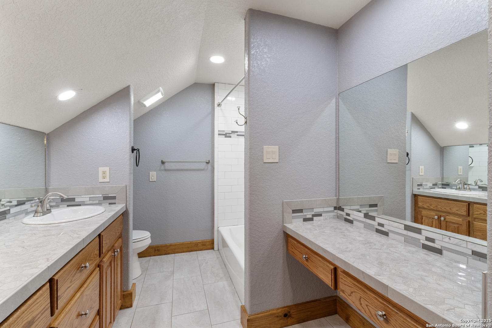 7040 Old Spring Branch Road Spring Branch, TX 78070 - Photo 26 of 43 a bathroom with a granite countertop sink a large mirror and a shower