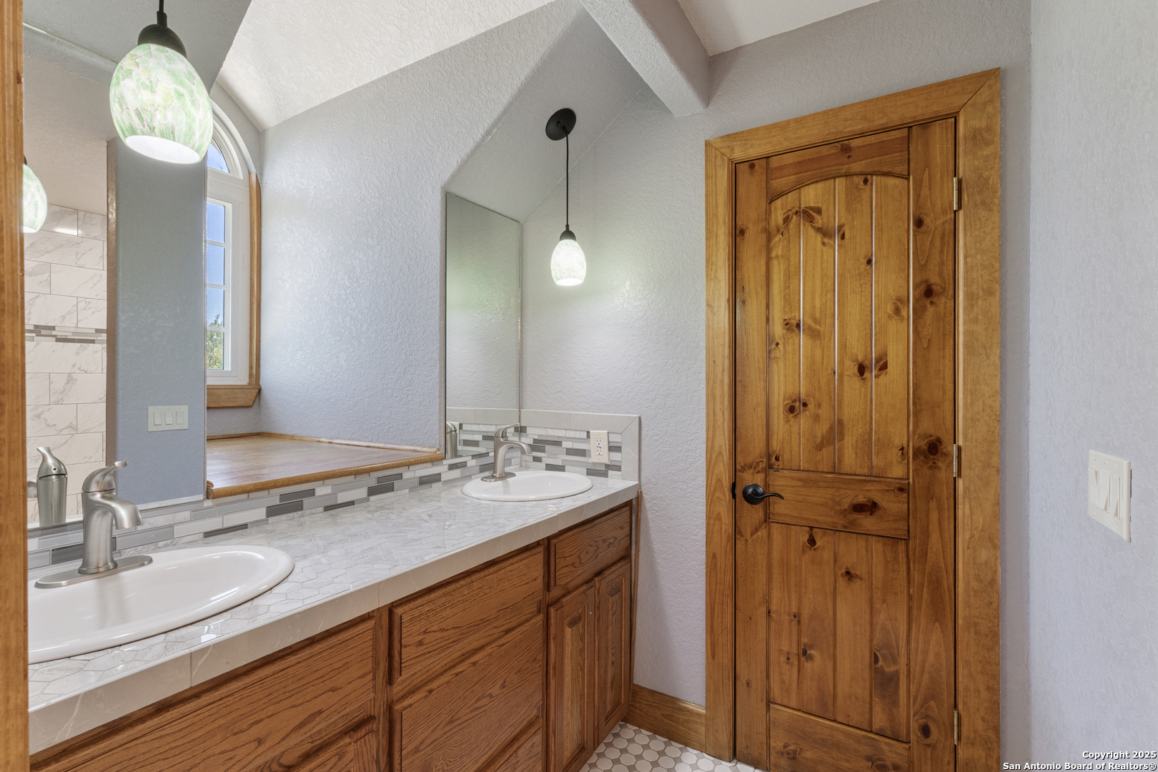 7040 Old Spring Branch Road Spring Branch, TX 78070 - Photo 28 of 43 a bathroom with a double vanity sink and a mirror
