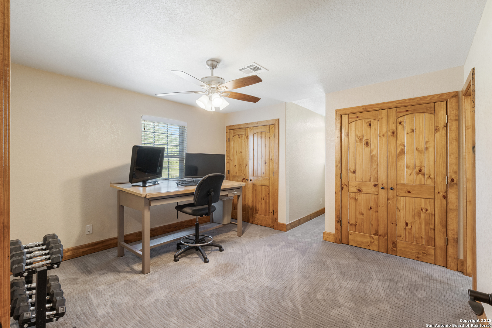 7040 Old Spring Branch Road Spring Branch, TX 78070 - Photo 30 of 43 a view of a workspace with furniture and a window