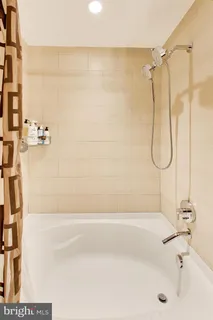 a bathroom with a bath tub with a shower