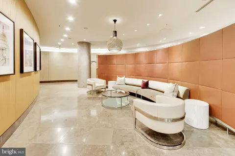 a lobby with a couch and a chandelier