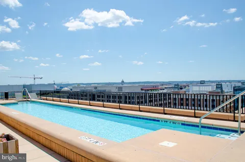 a view of a swimming pool with outdoor seating and yard