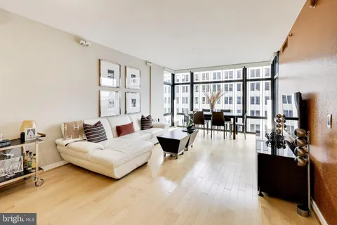 a bedroom with furniture and a large window