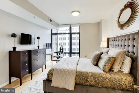 a bedroom with a bed and flat screen tv