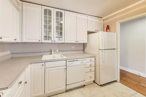 a white refrigerator freezer sitting inside of a kitchen