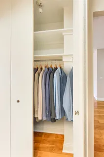 a view of walk in closet with clothes