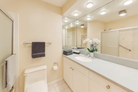 a bathroom with a sink a toilet and mirror