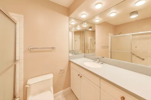 a bathroom with a sink and a mirror with shower