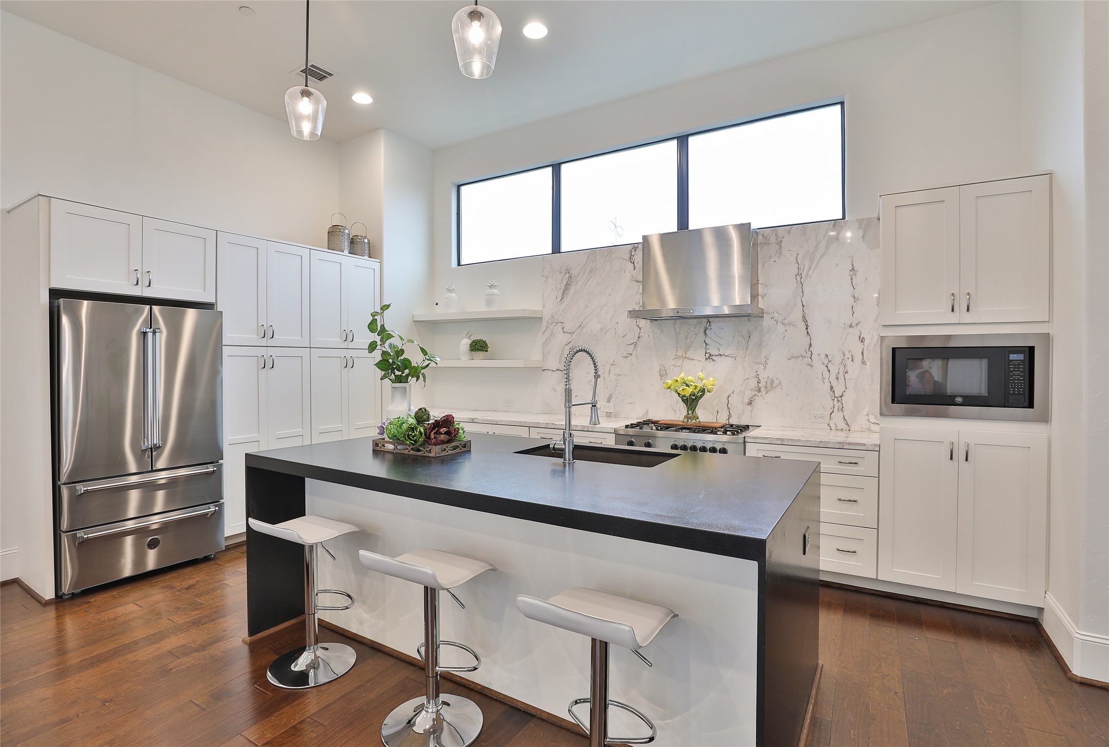 Bergatonni appliances, Carrera marble counters/backsplash, Mid Continental shaker cabinetry and "leather look" stone breakfast island are simply show stopping!