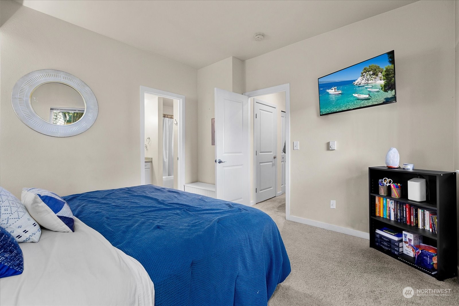 3915 243rd Place Southeast, Unit K103 Bothell, WA 98021 - Photo 13 of 36 a bedroom with a bed and a mirror