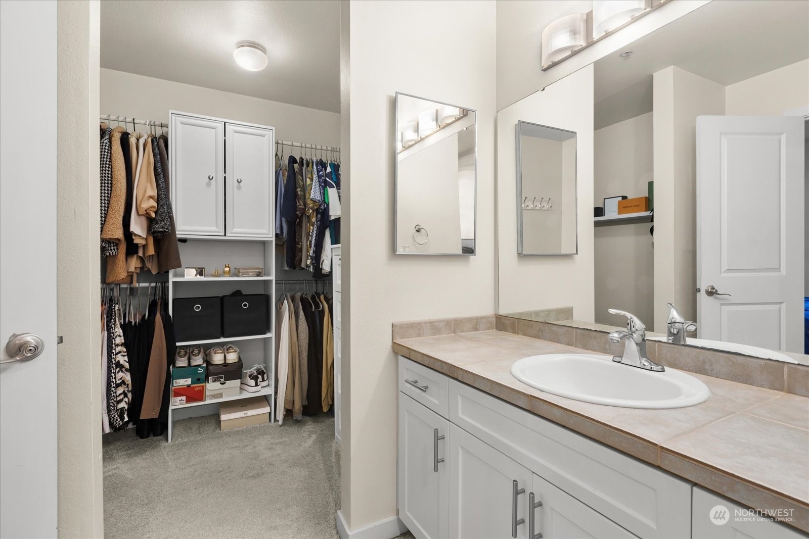3915 243rd Place Southeast, Unit K103 Bothell, WA 98021 - Photo 15 of 36 a en suite bathroom with a granite countertop sink and a mirror