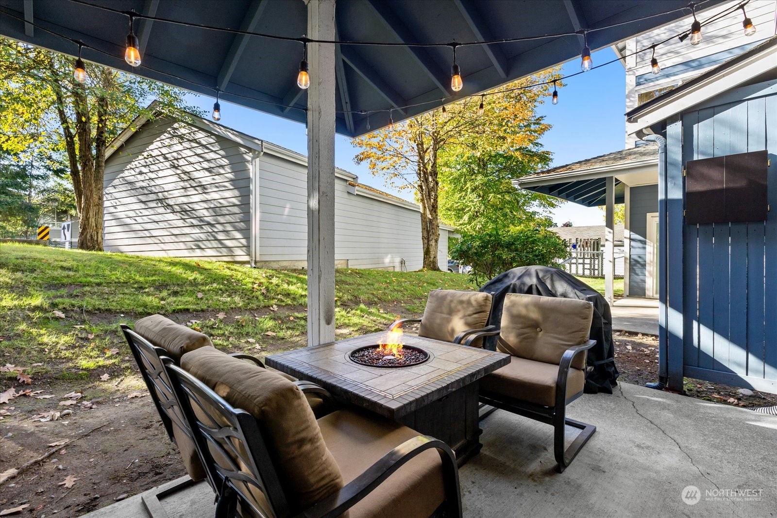 3915 243rd Place Southeast, Unit K103 Bothell, WA 98021 - Photo 24 of 36 a view of a patio with a dining table and chairs with wooden floor and fence