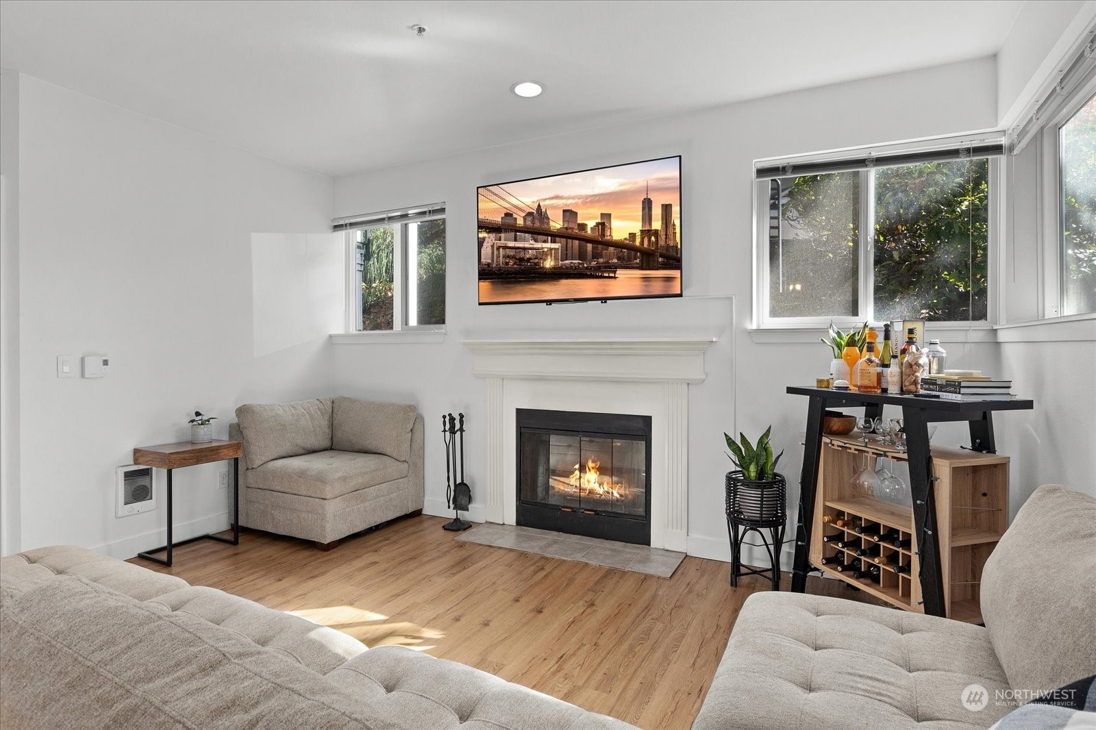 3915 243rd Place Southeast, Unit K103 Bothell, WA 98021 - Photo 4 of 36 a living room with furniture a flat screen tv and a fireplace