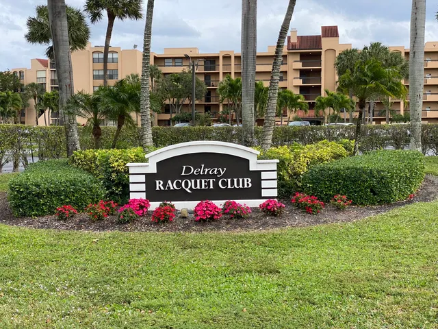 a view of multi story residential apartment building with a yard